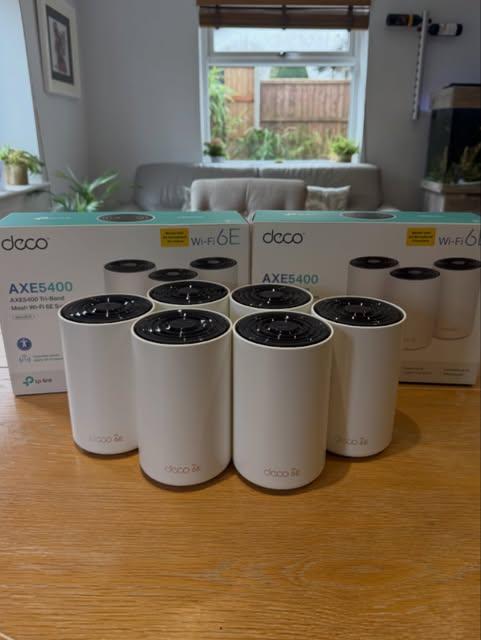 TP-Link Deco AXE5400 WiFi 6E mesh units laid out ready for residential installation